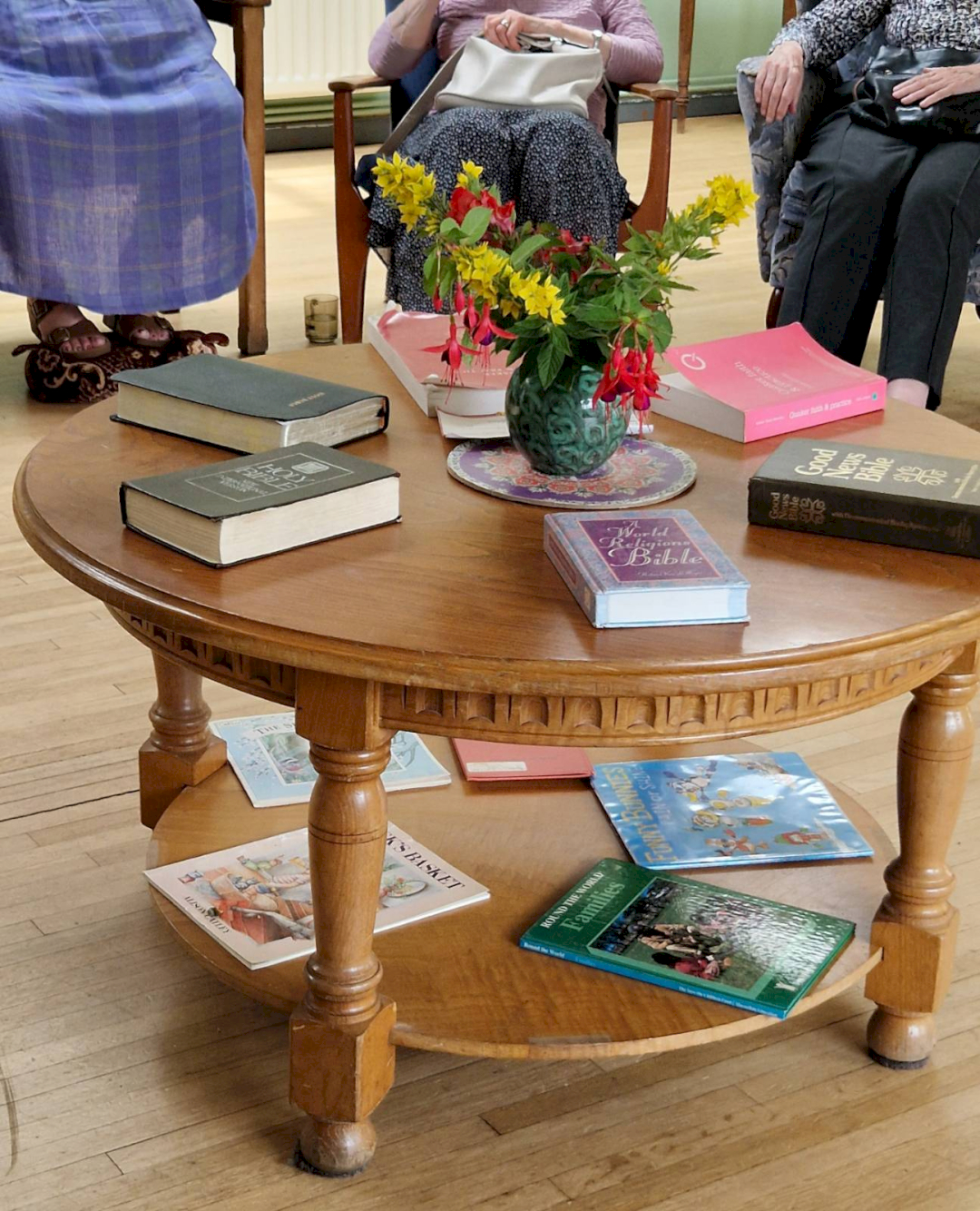 Our table during meeting for worship, on the table are beautiful flowers, copies of Quaker Faith and Practice, The Bible and a small selection of children's books.